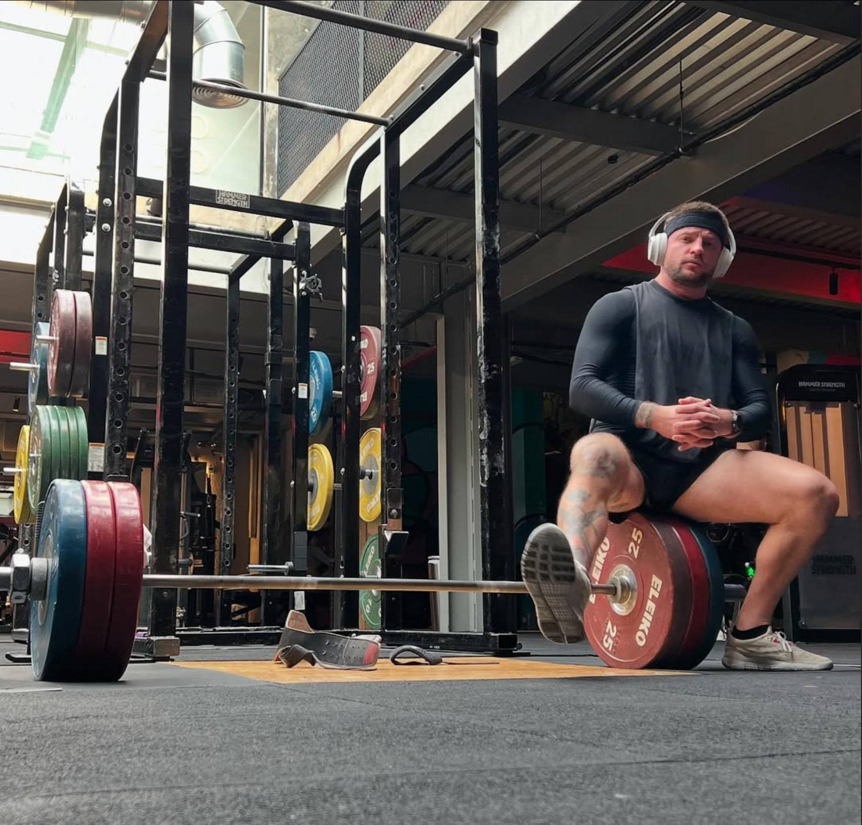 Artie Filippenko in the gym next to a loaded barbell